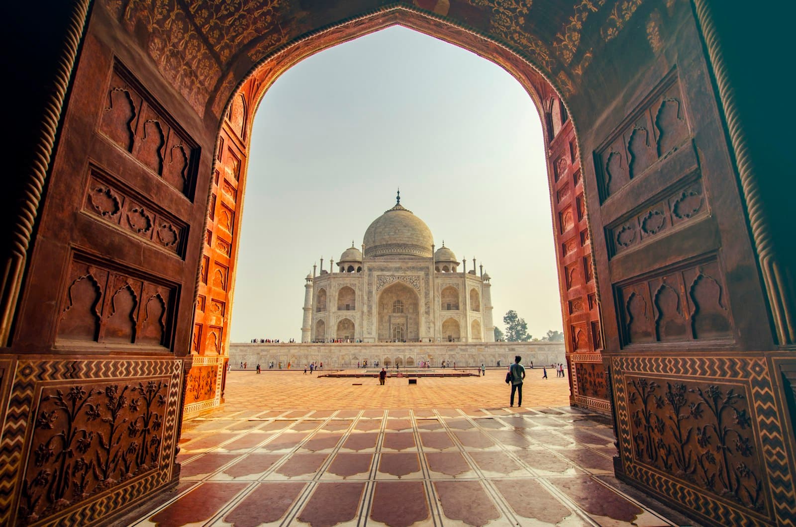 Warm terracotta archway framing a domed marble palace